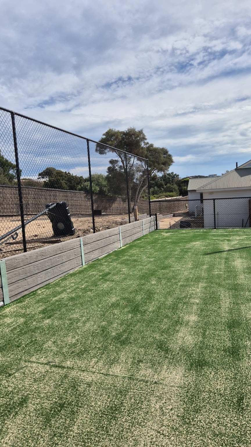 Completed black tennis court fencing in Blairgowrie showing the 3m high end fence meeting the 1.2m side fence