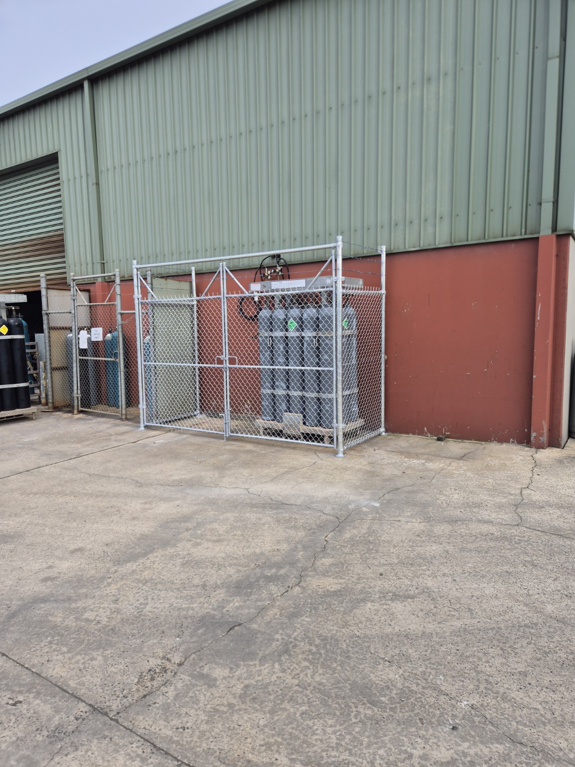 Wide view of a completed bolt-down gas security cage beside the Burra Sheetmetal building