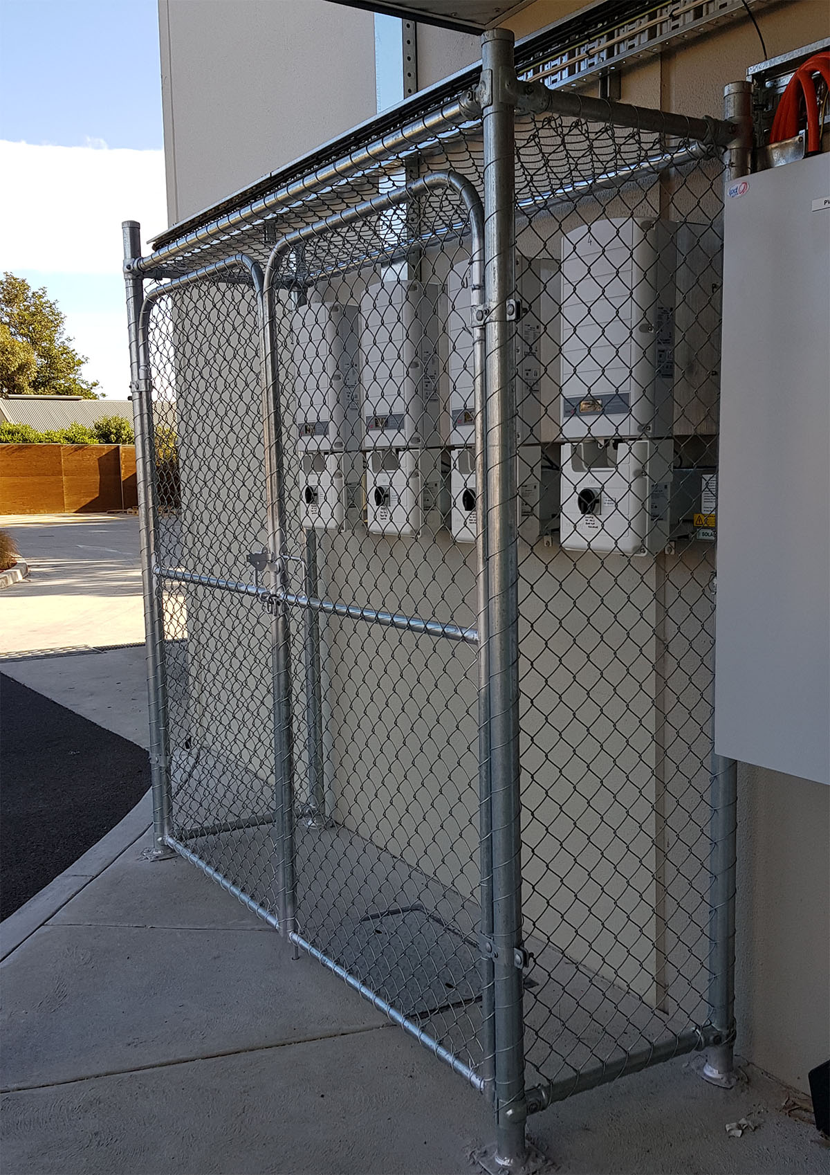 Black commercial chain mesh enclosure built inside an industrial facility