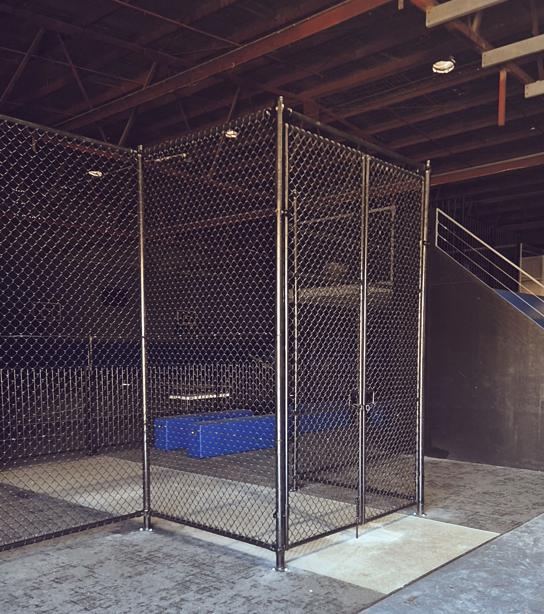 Galvanised chain mesh enclosure protecting a generator on a commercial site