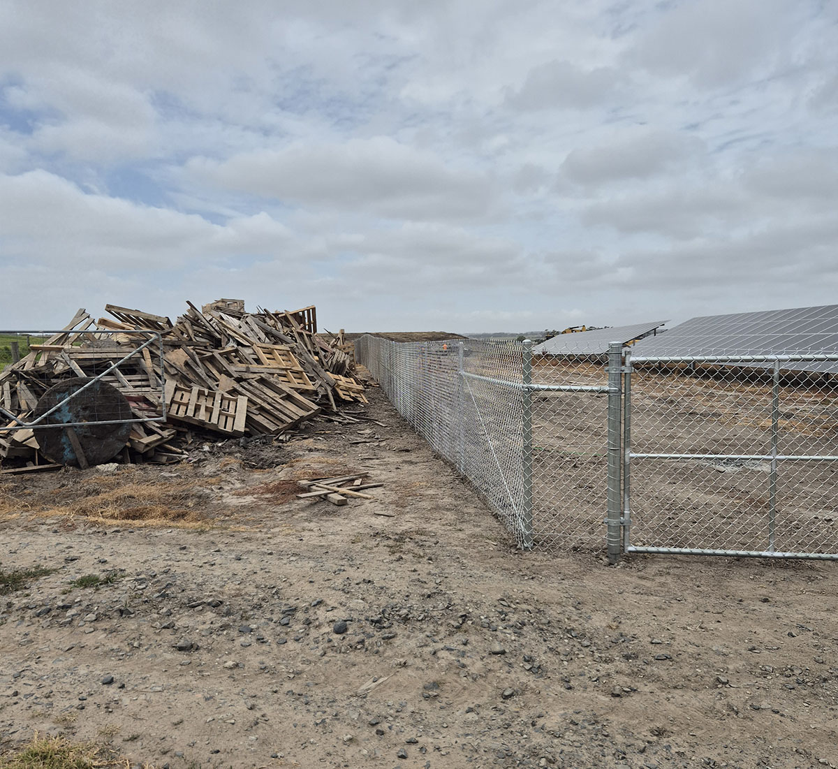 Galvanised commercial perimeter fencing beside a solar array installation