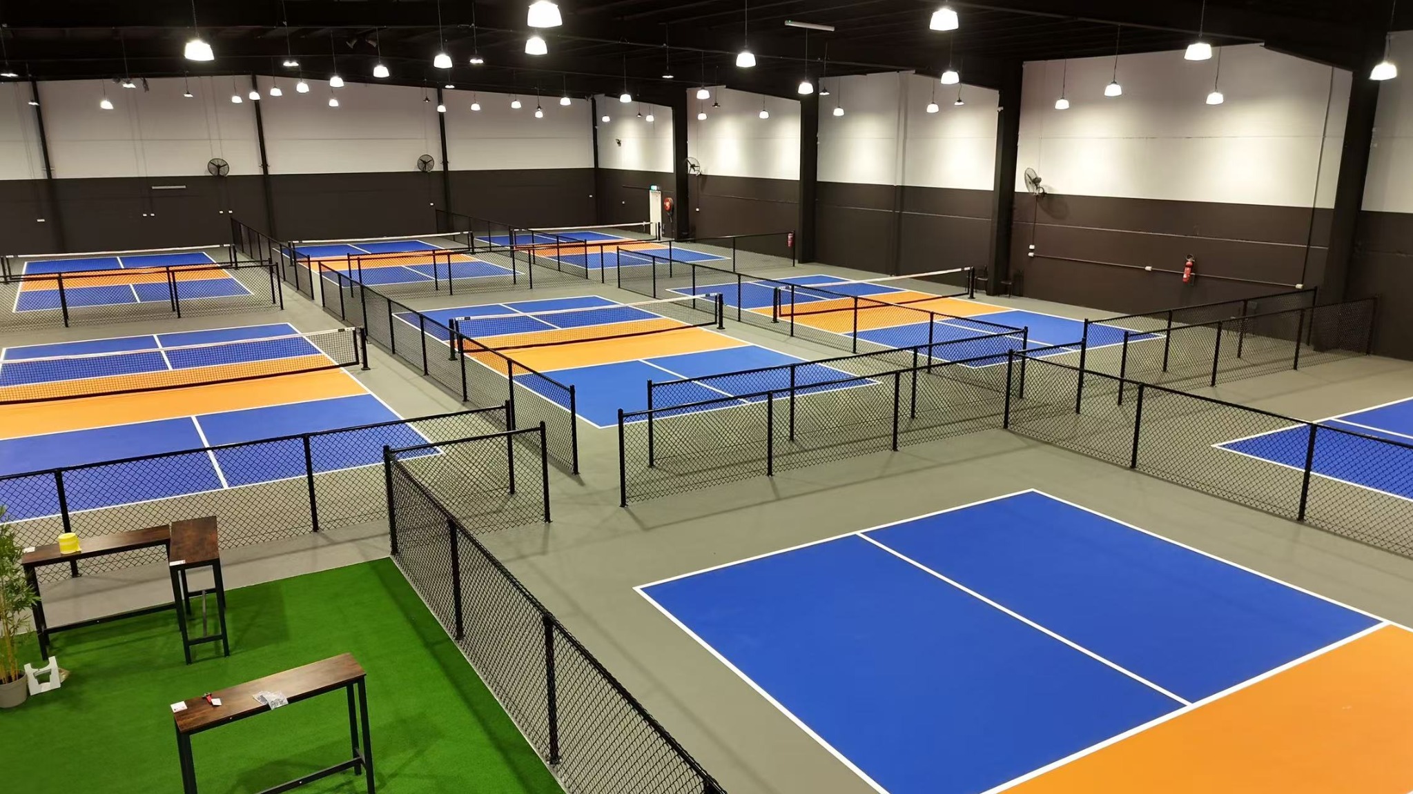 P4R Pickle 4 Real indoor sports facility with black chain mesh court fencing