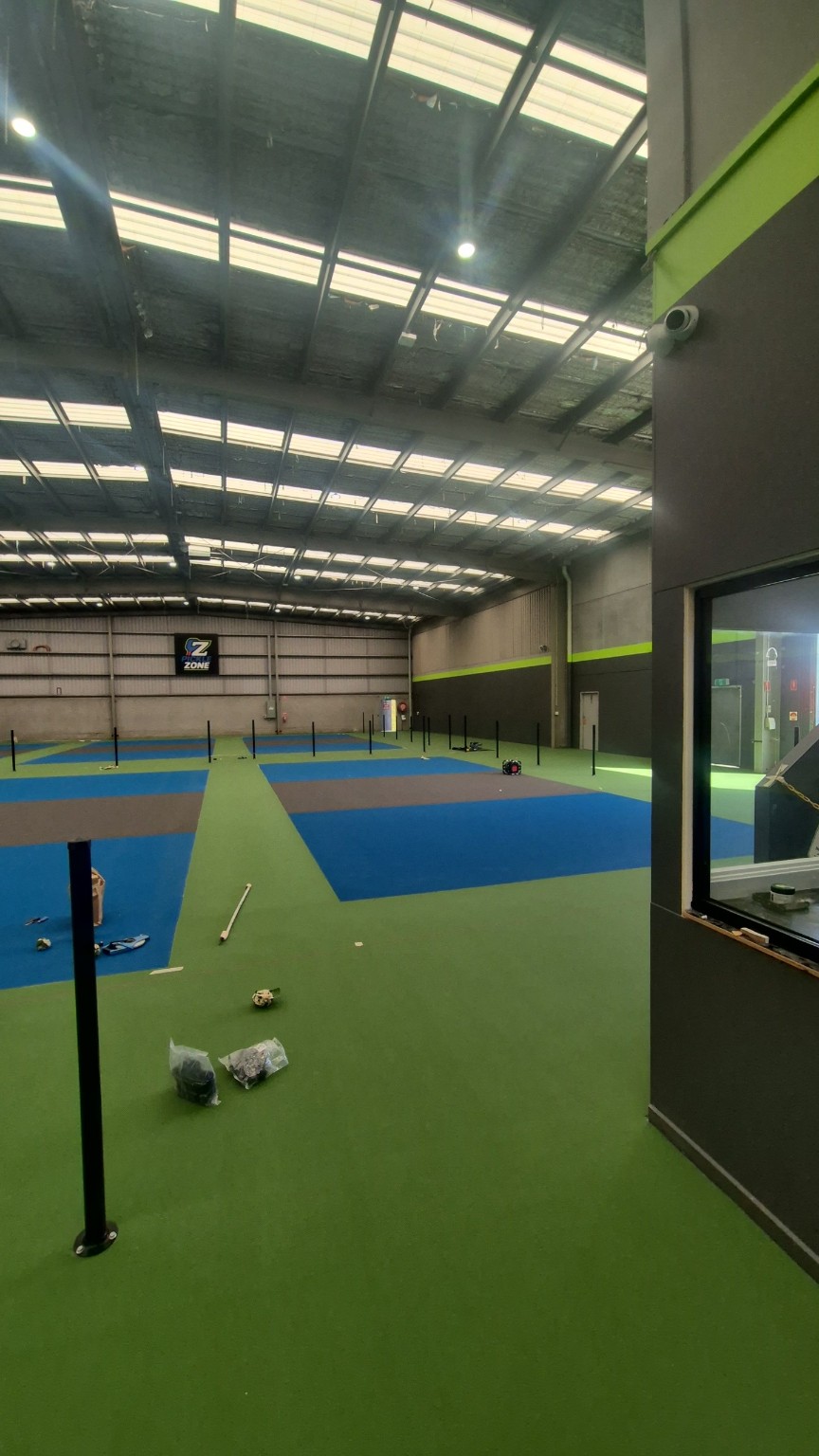 View across the Pickle Zone courts during installation of the base-plated fence posts