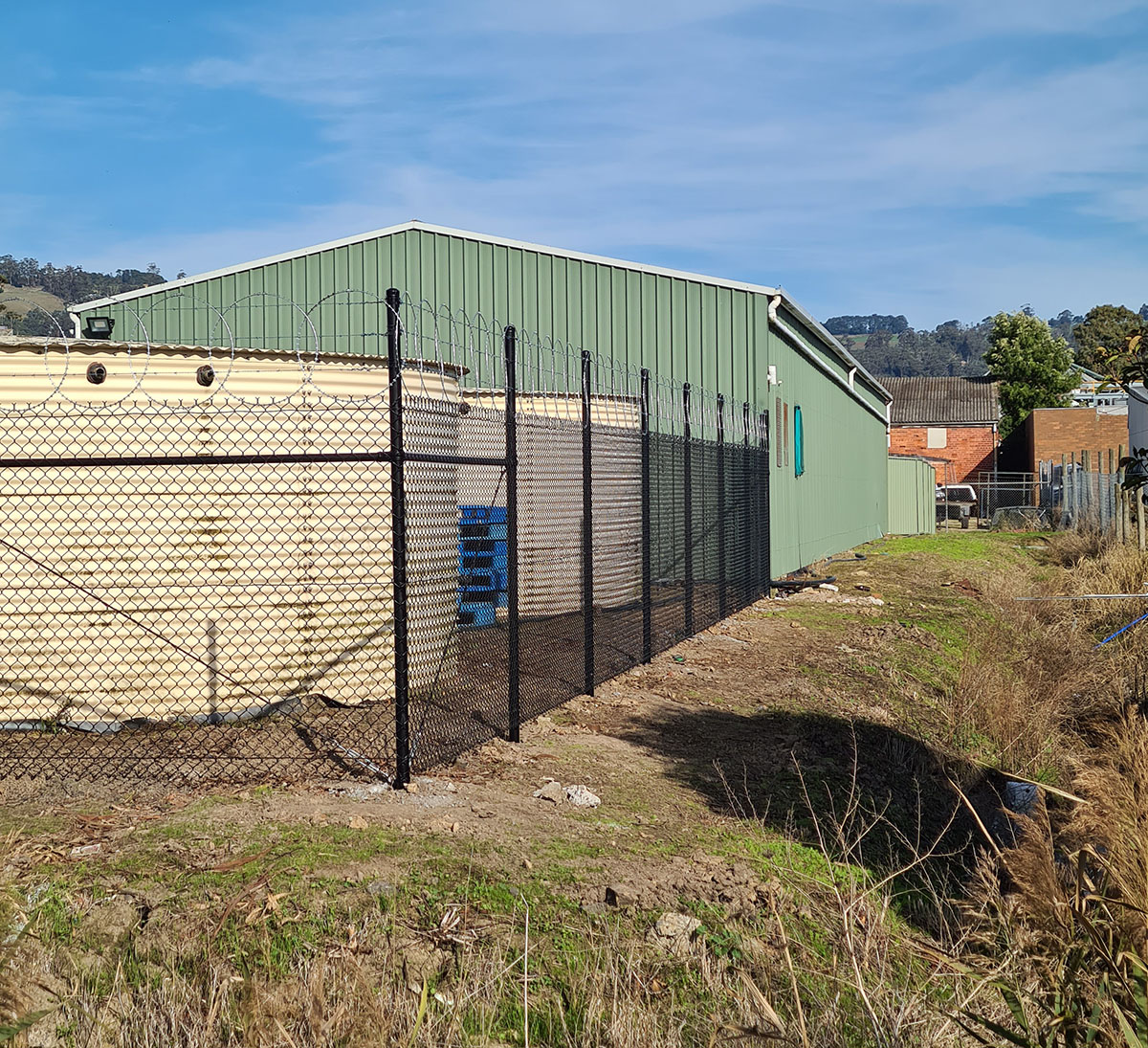 Galvanised chain mesh security gate and fencing at a commercial property