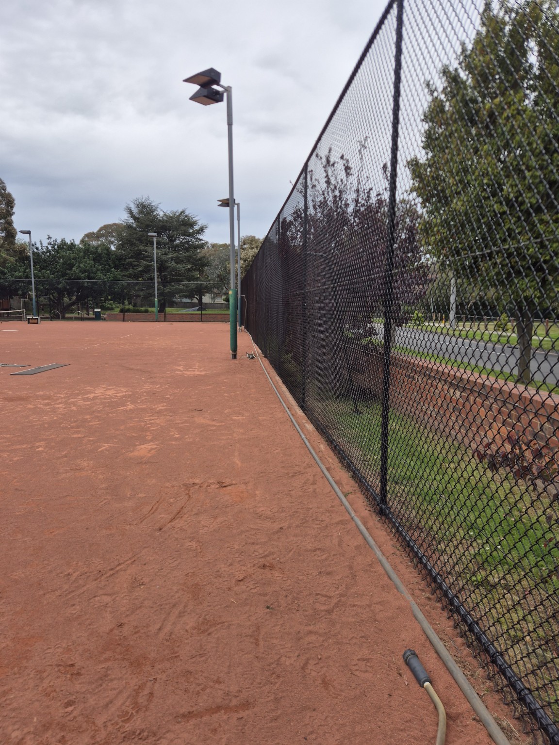 New 3600mm high black chain mesh with top and bottom rails along the red tennis courts at Willison Park