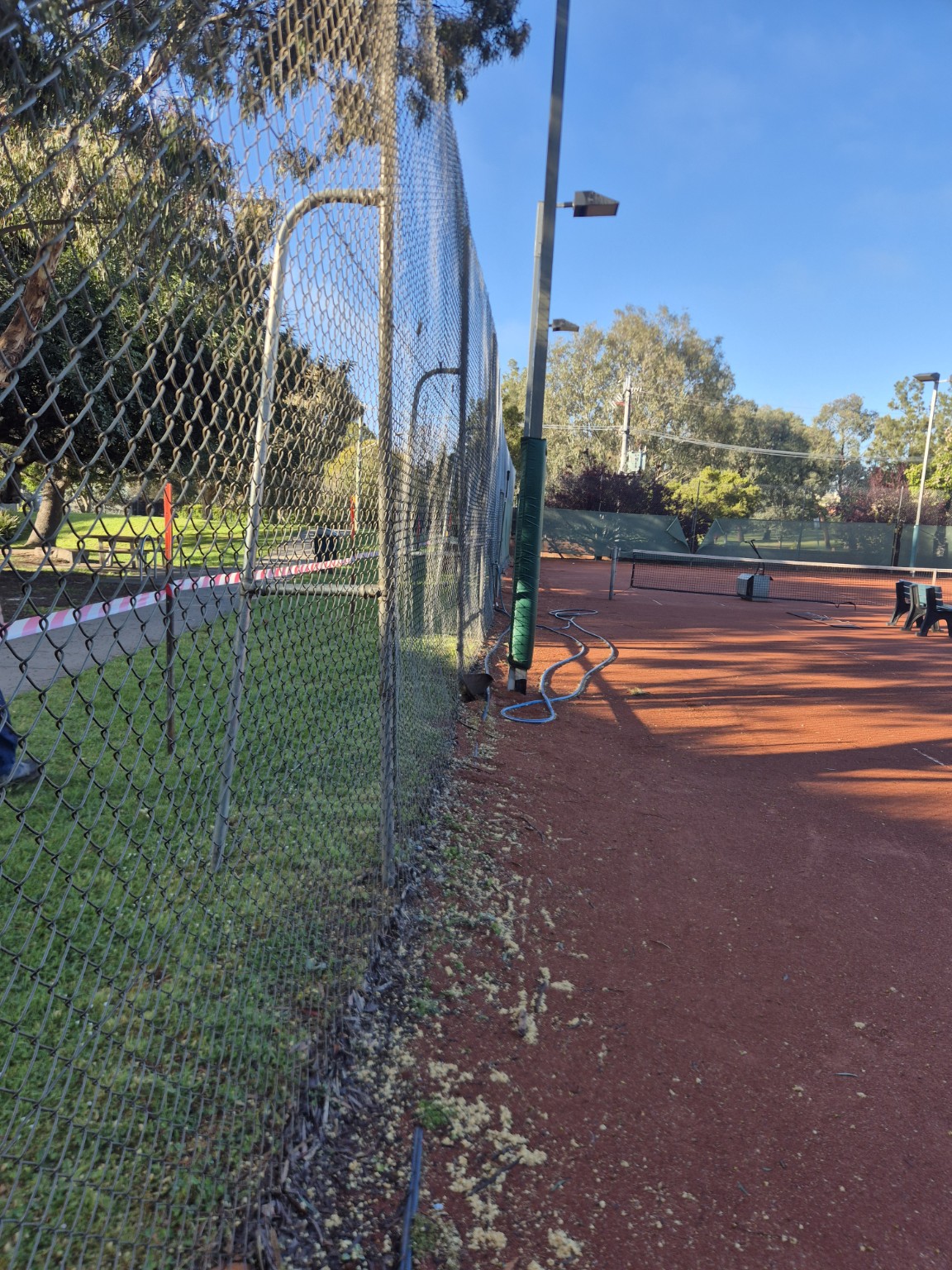 Old galvanised tennis court fence and pedestrian gate before renovation at Willison Park Tennis Club